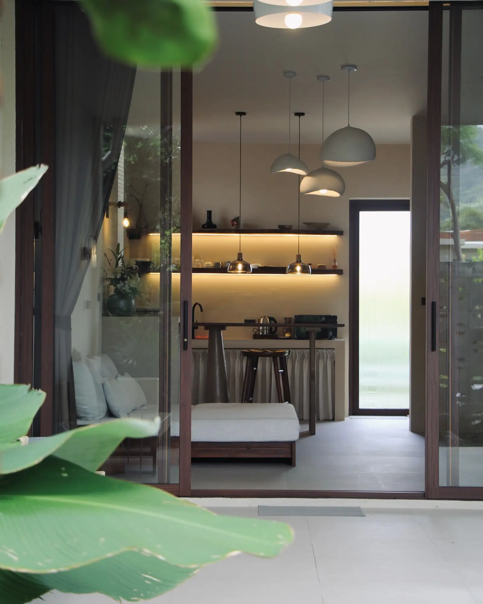Looking from the garden into the villa through glass doors